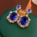 Vintage luxury earrings featuring oval blue zircon gems with gold and silver metal floral accents - Silver Pin Blue Zircon Oval Earrings