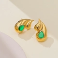 Macro detail of 18k gold double-layered teardrop earrings with green gemstone - Gold + Green Zirconia