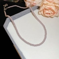 Detail of lavender pearl beaded necklace featuring a metallic lobster clasp and adjustment chain - 6mm / Lavender