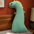 Soft mint green long dinosaur plush pillow with yellow fins in a cozy bedroom - Green Dinosaur