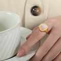 Vintage rose quartz ring with matte gold finish on hand with soft elegant lighting - US 6 / Gold Band / Rose Quartz