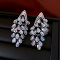 Macro view of silver geometric earrings with sparkling diamonds and crystal drop tassels - Gun Black Transparent