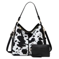 Detail of cow print tote bag and black pouch set with premium golden hardware - Two-Piece Set / Cow Print Black