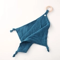 Detail of dark blue muslin baby comforter with natural wood teething ring and knotted corners - Royal Blue
