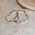 Polished silver irregular wave hoop earrings displayed on elegant beige texture - Irregular Heart (15#)