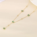 Close-up of gold chain with green butterfly pendants and sparkling zircon accents - Green (KN287984-BI)