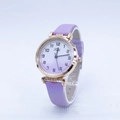 Detailed macro view of purple gradient dial with Arabic numerals on small leather watch - Purple
