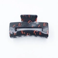 Halloween claw clip featuring orange pumpkin prints on black smooth plastic finish - Specter