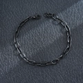 Professional close-up of a black stainless steel Cuban link bracelet with a lobster clasp. - Box Chain / Black