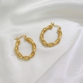 Twisted rope design hoop earrings in 18K gold finish on a white silk background - Gold (Twisted Pattern)