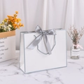 White cardstock gift bag with grey satin bow and silver trim for elegant shopping - 30*25*10cm / White with Silver Edge + Grey Ribbon