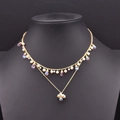 Collar de doble capa dorado con perlas y gotas iridiscentes en un busto negro - Collar de Cristal Irisado de Doble Capa