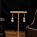 Pink beaded drop earrings with white pearls and gold flower caps on T-stand - Pink Bead Pearl Gold Base (E5482)