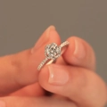 Silver flower ring with a round center stone and pave zircon petals held by hand - Blooming Ring Ljz-119 / Adjustable Open