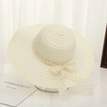 Cream white straw sun hat for women featuring a gold polka dot ribbon bow and wide brim - Gold Dot Creamy White