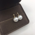 Macro detail of white freshwater pearls on golden ear hooks inside a jewelry box - 9mm Gold Base Button Pearl Silver High Heel