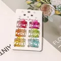 Detail view of 6 colorful mini bow hair claws on a cat-themed display card with springs - Gradient Figure-8 Knot