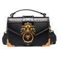 Retro black faux leather crossbody bag with golden lion head and striped strap - Black