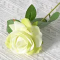 Single realistic yellow faux rose with layered velvet petals and green leaf stem - Elsa Green