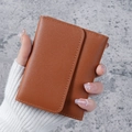 Brown minimalist tri-fold short wallet for women featuring smooth texture and fine stitching - Brown