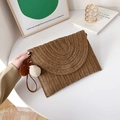 Brown handmade woven straw envelope clutch with decorative pom poms and wrist strap - Brown