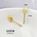 Detailed view of golden flower charms with faux pearls and rhinestones on beige fabric - 4495# Flower