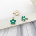 Green enamel flower charms with gold edges and white centers for DIY jewelry making - Flower