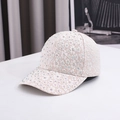 Close-up of the elegant white lace fabric and sparkling colorful rhinestones on the baseball cap - One Size / Khaki