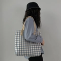 Blue plaid canvas tote bag with beige handles shown on model in a casual daily style - Light Blue Plaid Check
