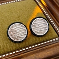 Detailed shot of retro silver earrings with black enamel trim on a green display tray - Silver/Black