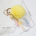 Detail view of yellow pompom keychain with resin letter N and dimensions in inches - Letter N