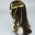Elegant olive green satin bow hair clip with long ribbons on side-view model - Army Green