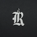 Detailed macro view of a silver Gothic letter R pendant in stainless steel for DIY jewelry - Letter R