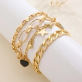 Set of four gold-colored bracelets with black heart, star charms and layered chain design - Gold Black Heart Star 4-Piece Set (9038)