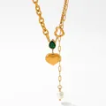 Golden necklace featuring a green teardrop gemstone, heart pendant, and pearl accent - Green Zirconia (KCD809)