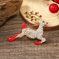 Exquisite gold reindeer brooch with clear crystals and red enamel on dark wood background - Reindeer - KC Gold Multicolor