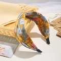 Yellow floral bow headband with blue patterns in a small woven basket display - Floral Knot Yellow (FK-B180 Yellow)