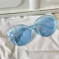 Stylish light blue translucent round sunglasses with oversized frames on white fabric - Jelly Round Blue Thick Frame