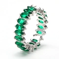 Macro shot of eternity ring with marquise-cut green emerald stones in silver setting - Silver + Green Zirconia