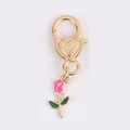 Close-up of pink rose charm with golden heart-shaped lobster clasp accessory - Rose Shape