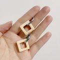 French vintage silver hoop earrings with cream square pendants held in hand - Square Off-white (Silver Hoop)