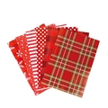 Red Christmas wrapping paper sheets with tartan, dots, stripes, and snowflakes patterns - Set