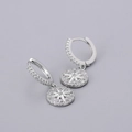 Detail of silver hoop earrings featuring starburst charms with sparkling zircon pavé - Star Ray Earrings - Silver