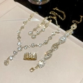 Luxe gold necklace bracelet earring and ring set with sparkling diamonds on display - Gold-White (Set)