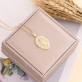 Close-up of Virgin Mary pendant necklace with cubic zirconia on a beige jewelry box - Oval Clear Zircon Style (2#)