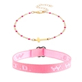 Detail of pink WWJD woven wristband and gold cross bracelet with magenta beads - Two-Piece Set / Pink Cross Style