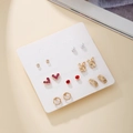 7-day gold earring set with faux pearls and red rhinestones on a display card - Red Rhinestone Rabbit Heart Style (E1989-1)