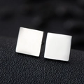 Polished silver square stud earrings in stainless steel on black leather background - Square / Silver