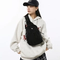 Lightweight black canvas crossbody chest bag with drawstring and silver cat metal detail - Black