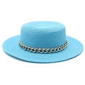 Macro shot of bright blue straw boater hat featuring a thick gold chain decoration - Lake Blue